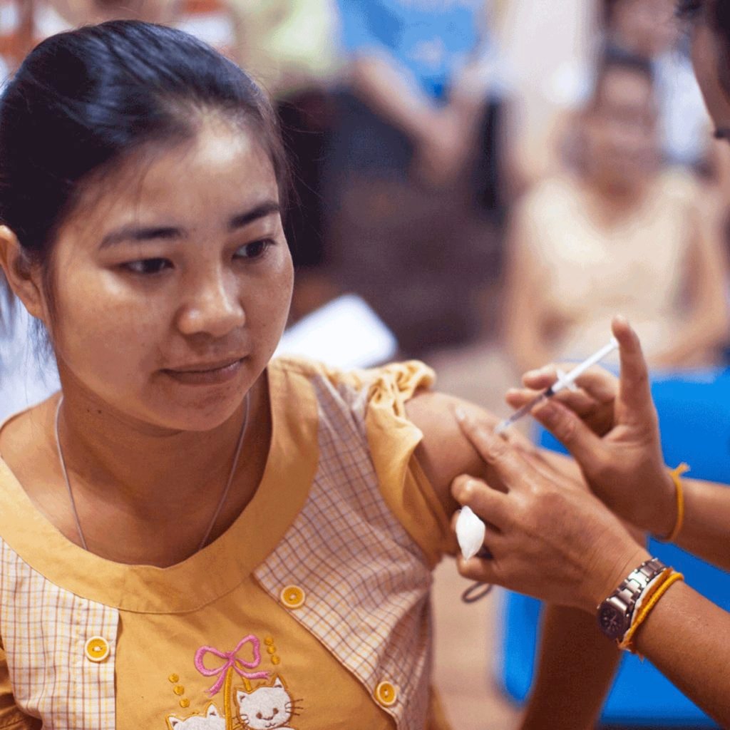 Photograph of a person administering a vaccine.